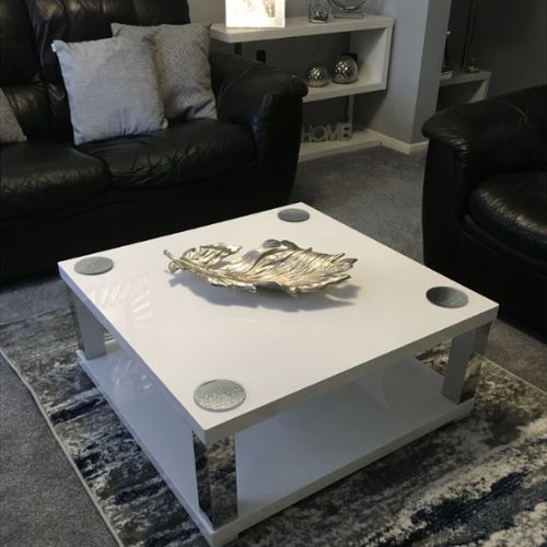square white high gloss coffee table with chrome silver legs and storage shelf in modern living room