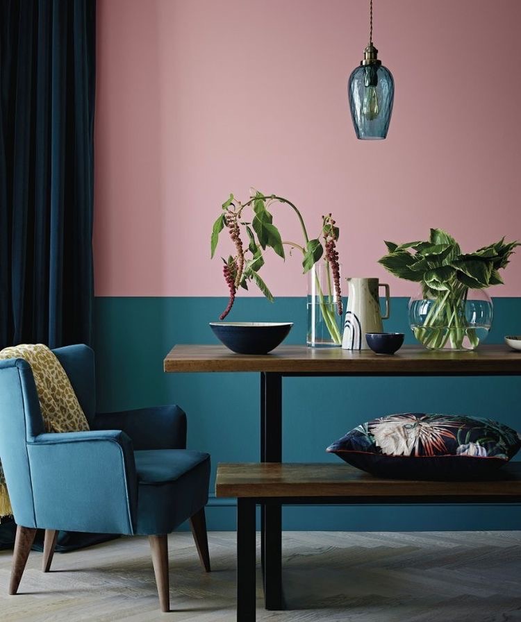A wall that uses colour blocking, with pink at the top and teal at the bottom