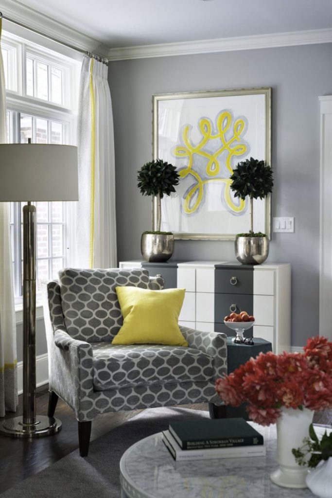 A living room using grey and yellow to balance colour
