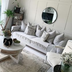 Modern shabby chic inspired living room with white sofa and coffee table