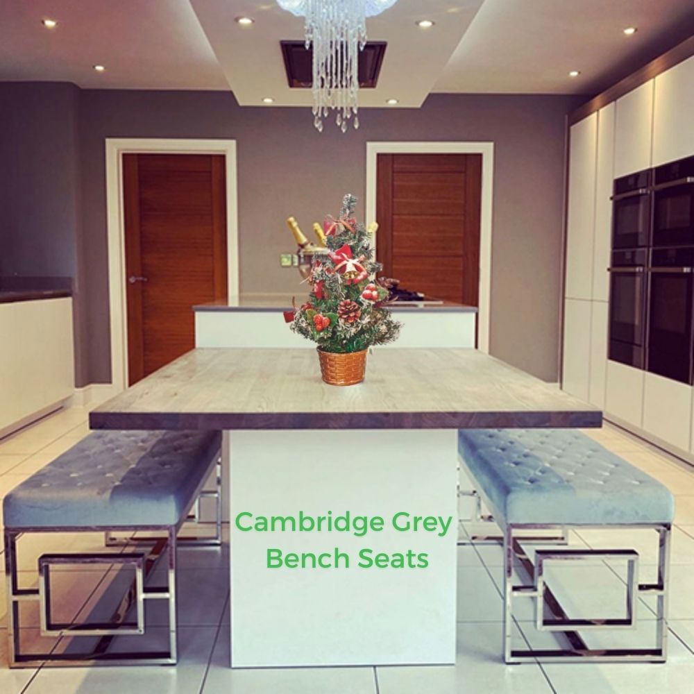 make room for guests - kitchen with large island table and 2 grey velvet topped bench seats with silver geometric art deco frame legs