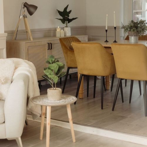 modern dining area with mustaard yellow velvet dining chairs and wamr neutral walls