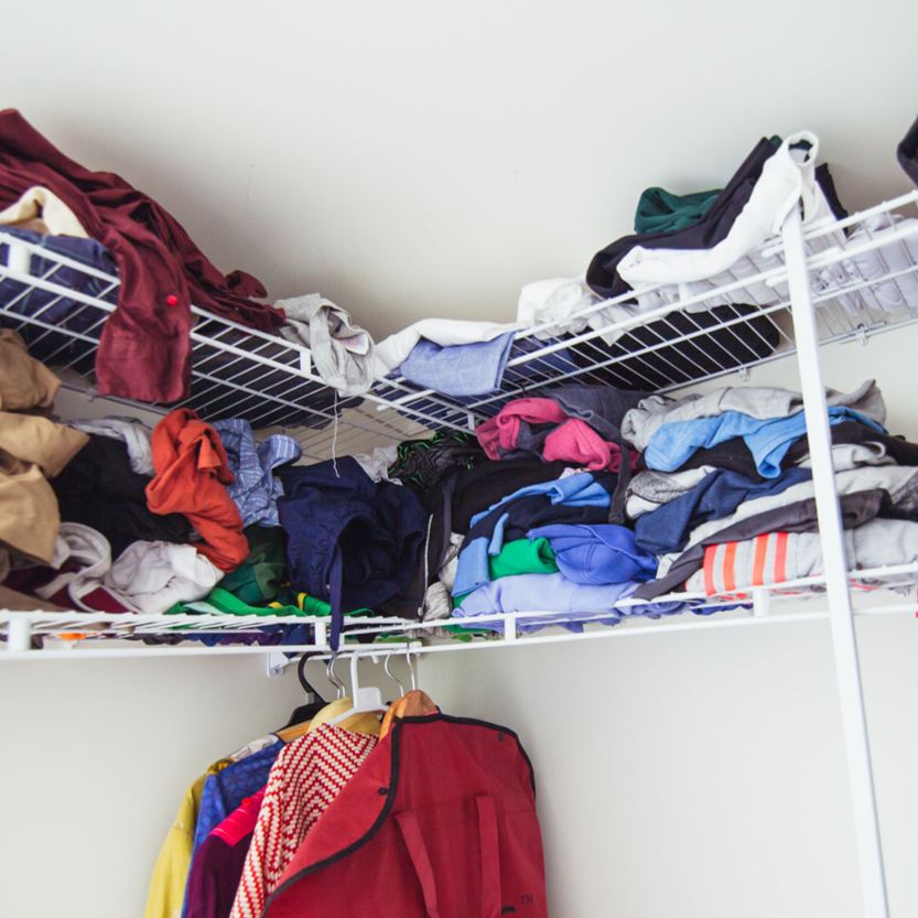 Image of a cluttered clothes cupboard - declutter to prepare your home for sale