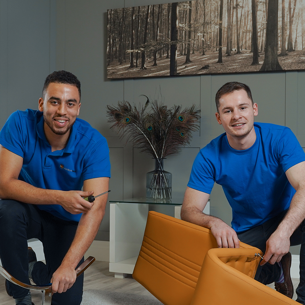 photo of two young men - one is mixed race, the other is white, kneeling and smiling at the camera as they construct a furniturebox uk dining chair. These are the Funriturebox founders.