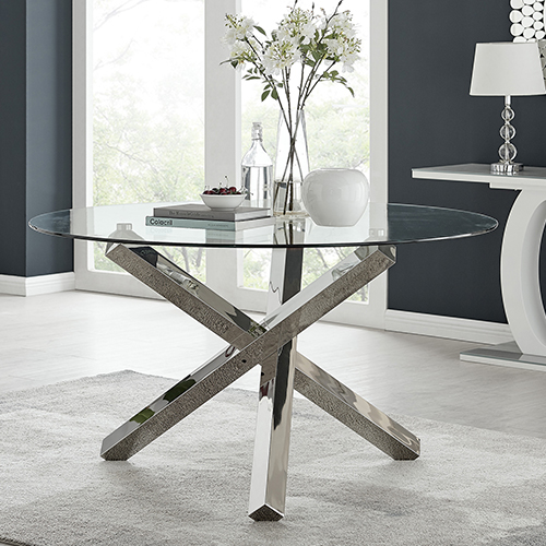 photo of round glass dining table with chrome legs sat on pale fluffy rug.