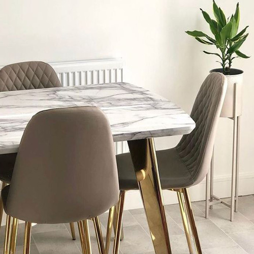 Scandi dining room look achieved with marble effect table top with grey leather chairs.