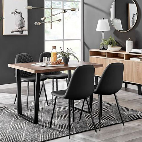 wooden effect table with black metal legs - scandi and industrial in style - with 4 black fuax leather chairs with black legs, in grey and white dining room.