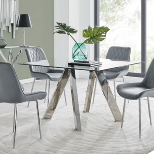 glass and chrome dining table on a rug. The rug is white and the walls are pale.