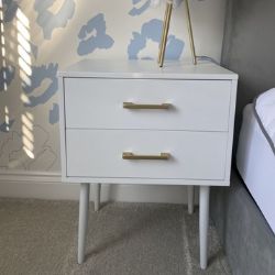 white wood bedside table with 2 drawers, tapered legs, gold handles