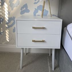 white wood bedside table with 2 drawers, tapered legs, gold handles