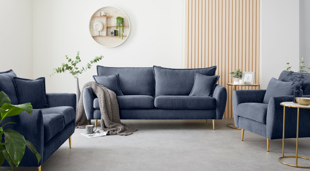 co-ordinated navy blue sofas and armchair with gold legs, in beige and white living room illustrate essentials of good livng room design throug 60 30 10 rule