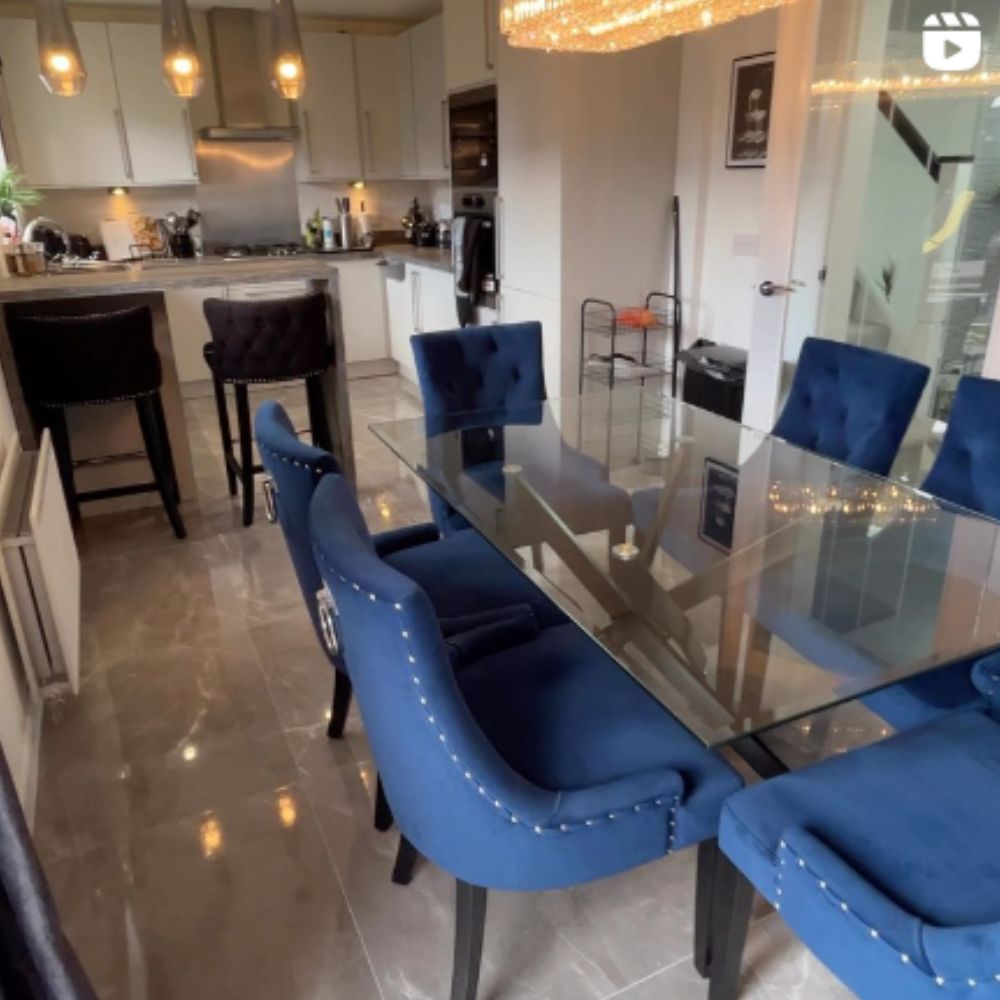 open plan kitchen-diner with bar table and bar stools acting as room divider.