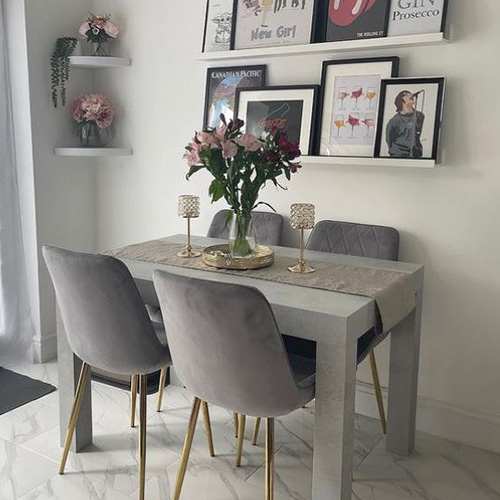 grey table and chairs with gold accessories and pink/red roses