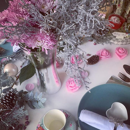 valentines table decor - white gloss table with mad hatter's tea party aesthetic in shades of pink, red, white and silver. 