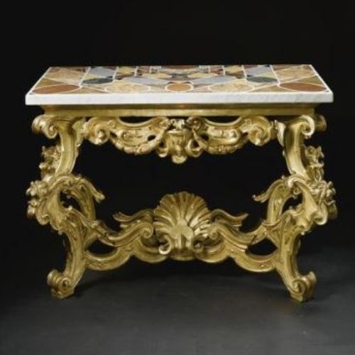 2-legged 17th century console table with gold scroll legs and bracket, and thick top inlaid with mosaic of different woods.