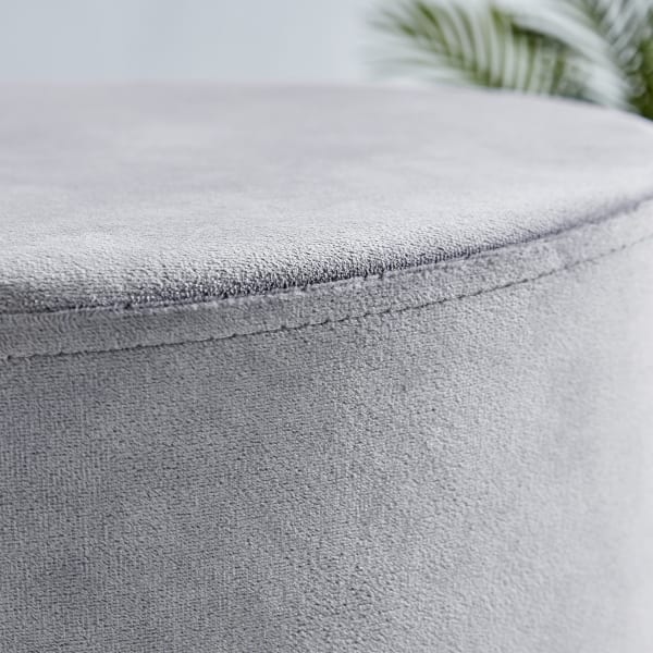 A close up of the grey velvet texture of the como stool