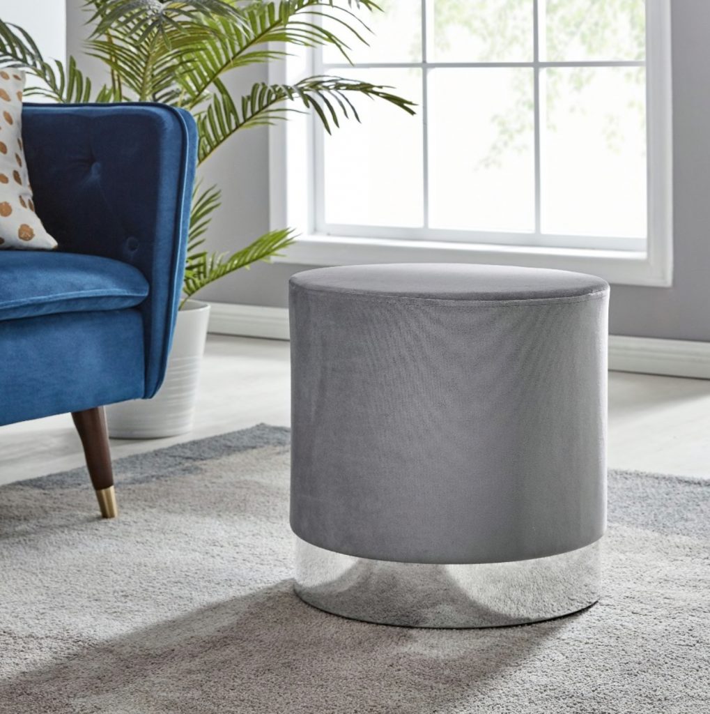 A grey velvet como stool adding texture to a room