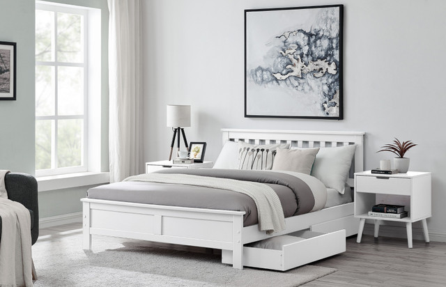 white pine double bed in modern bedroom with twin bedside tables