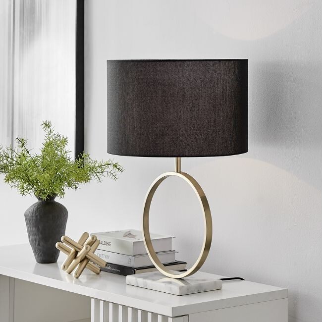 modern statement table lamp with white marble base, brass halo stand and black fabric lamp shade