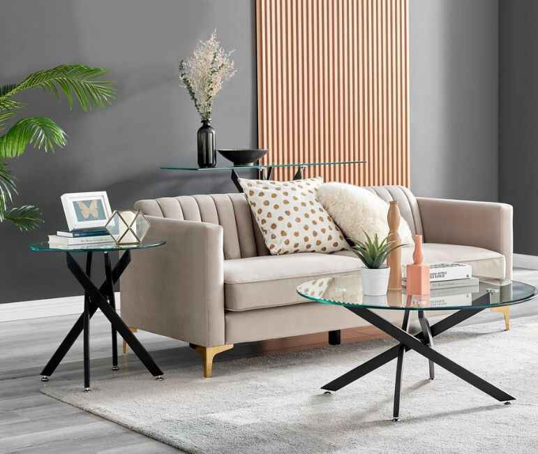 modern living room with grey sofa and black metal round coffee table with glass top and matching side table