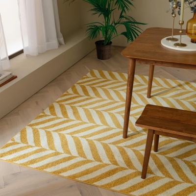 bold yellow and cream chevron rug under wood dining table