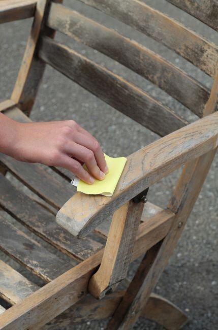 how to clean wooden garden furniture - cleaning outdoor chair with soft sponge