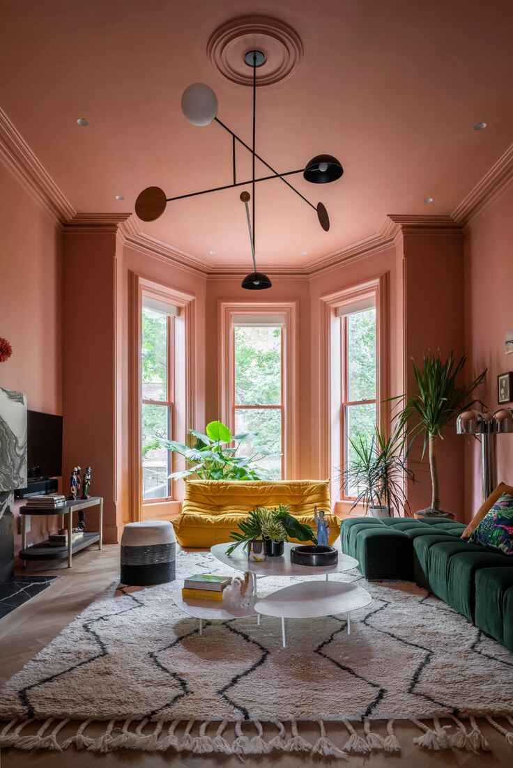 colour drenched living room in terracotta orange with large bay window