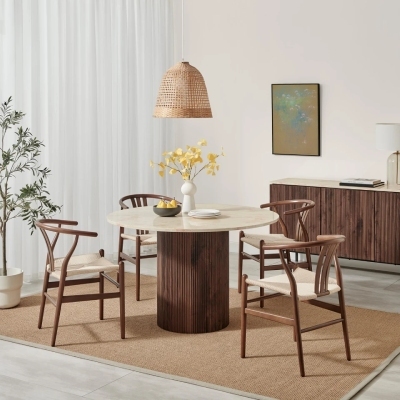 modern warm and cosy dining room with round wood and cream marble effect table with wood wishbone chairs