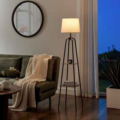 cosy living room with tripod standing lamp that has 2 display shelves