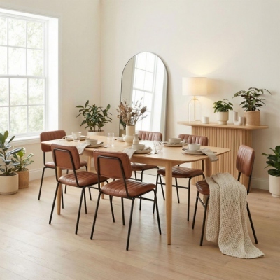 dining room lighting ideas - mid century modern wood dining table with 6 tan faux leather chairs, oak wood console table in back with cream and glass table lamp