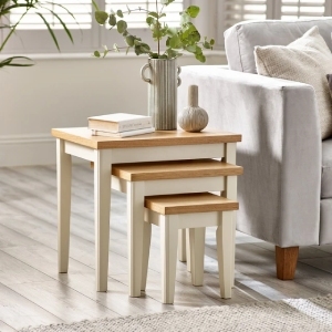 set of 3 cream and wood nesting side tables in bright cosy modern living room