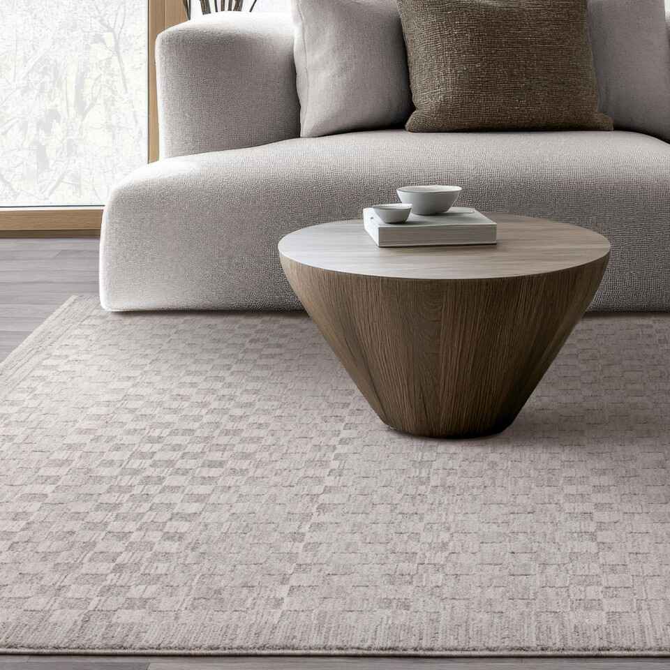 grey checkerboard rug with low pile great for dining rooms, shown here in living room with coffee table and sofa