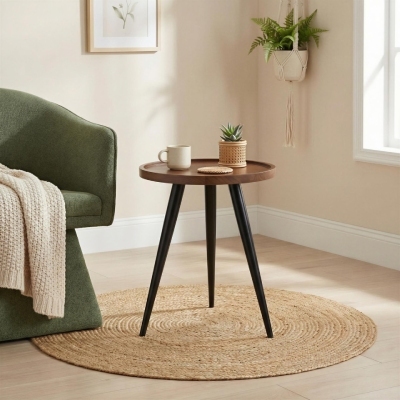 mid-century modern style round side table beside green fabric accent chair