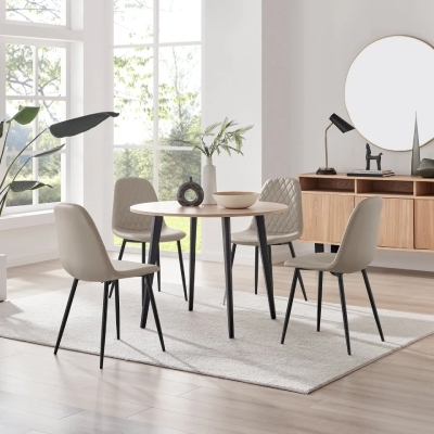 minimalist dining room in neutral colours with round wood table and 4 beige faux leather chairs