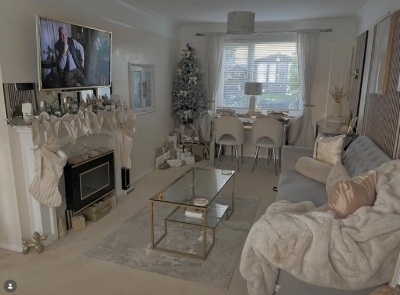 small living room with dining area, with glass and chrome dining table, grey sofa, mirror fire surround