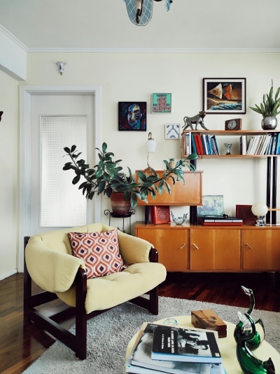 modern take on a 70s inspired living room with sidebpard and fabric accent chair