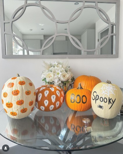 round glass dining table covered in Halloween decor