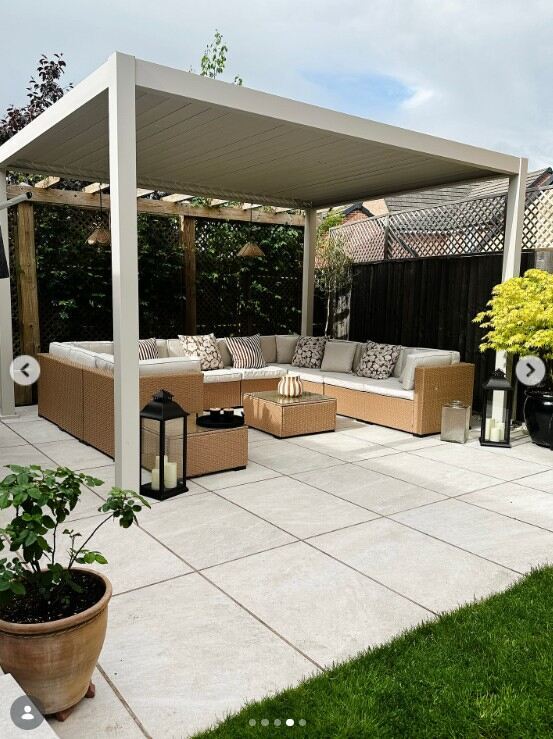  Beige Rattan & Cream 10 Seat Modular Garden Sofa under white pergola on white paving slabs on lawn