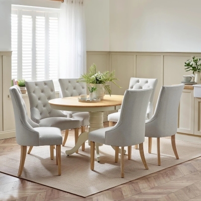 round wood farmhouse dining table with 6 grey velvet tall back dining chairs in a Bridgerton inspired dining room