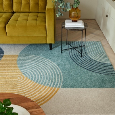 bold abstract coloured arches rug in modern living room with mustard yellow velvet sofa