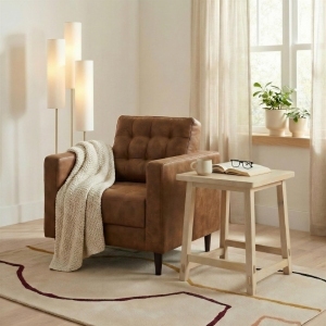 small square wooden side table beside tab leather armchair in modern living room