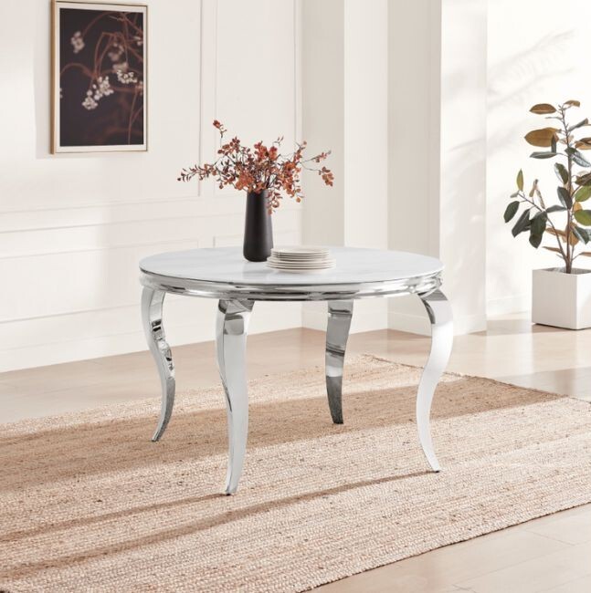 round white marble and silver metal dining table with curved legs in modern birght dining space