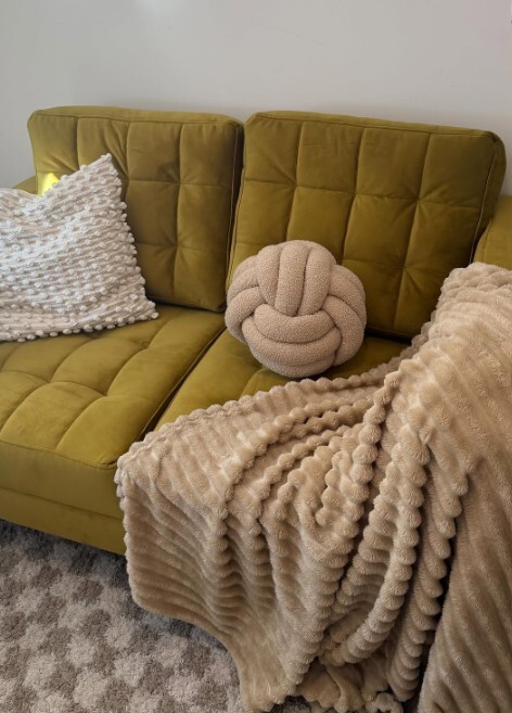 mustard yellow green velvet sofa dressed with velvet cushions and throw