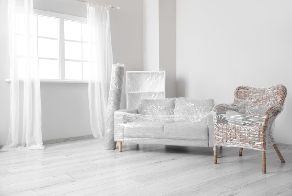 living room with furniture wrapped in cling film ready to move house